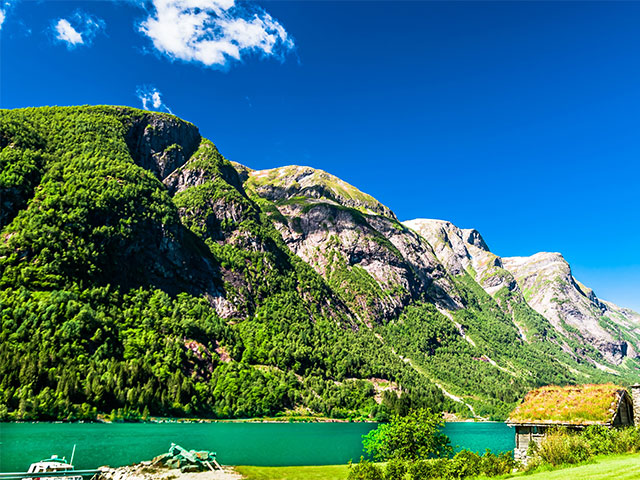 Typical wooden red buildings next to Sognefjord in Norway
