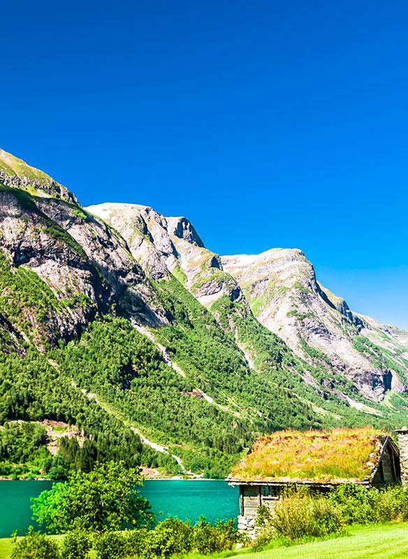 Typical wooden red buildings next to Sognefjord in Norway