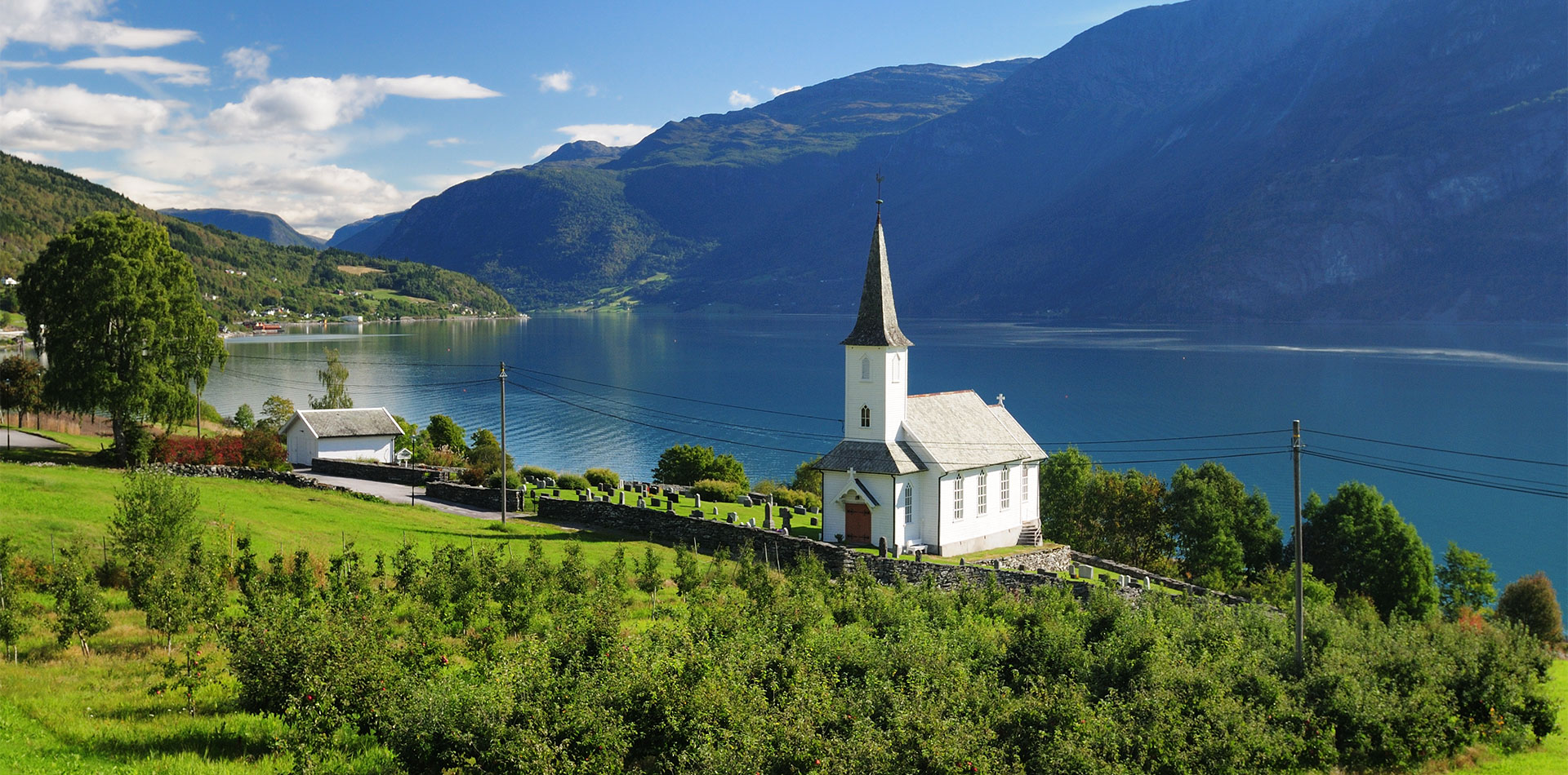 View To Lustrafjord With A White Wooden Chapel, Norway